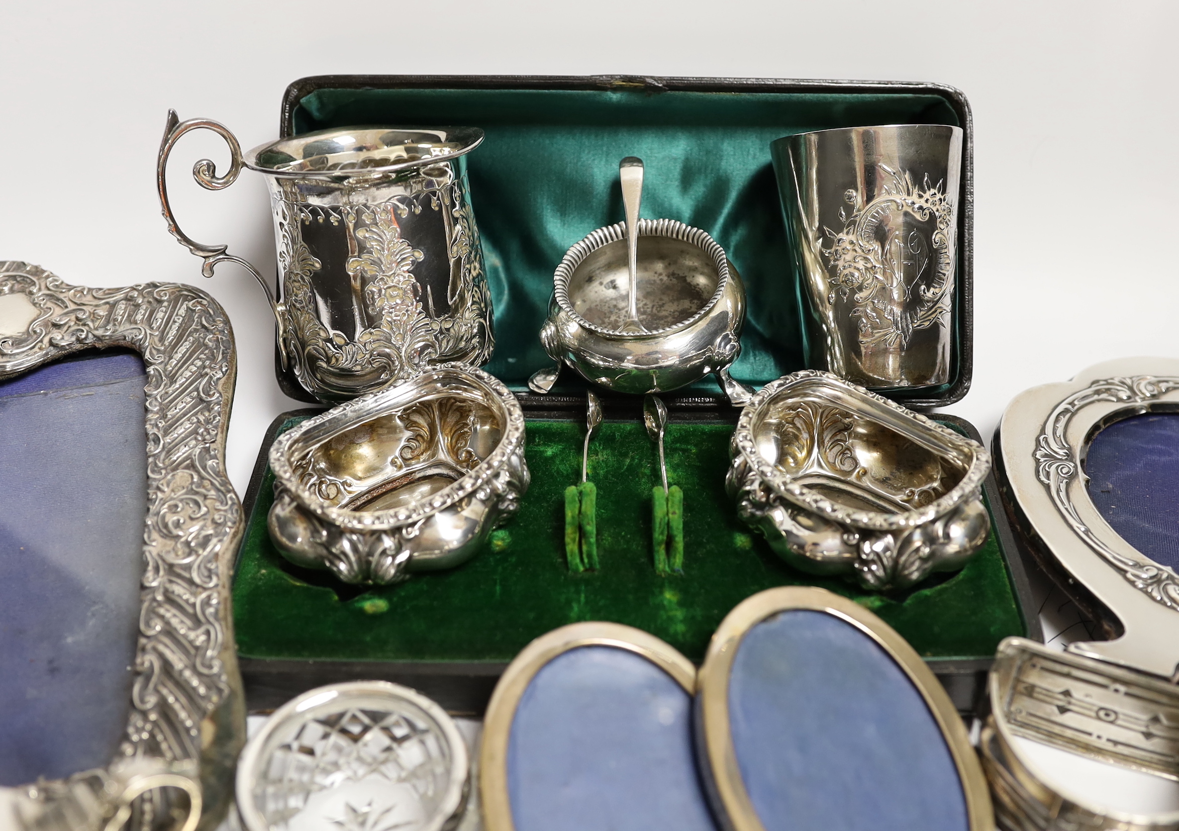 Sundry small silver and white metal items including Edwardian Christening mug, four mounted photograph frames, napkin rings, card cases, bun pepperette etc.